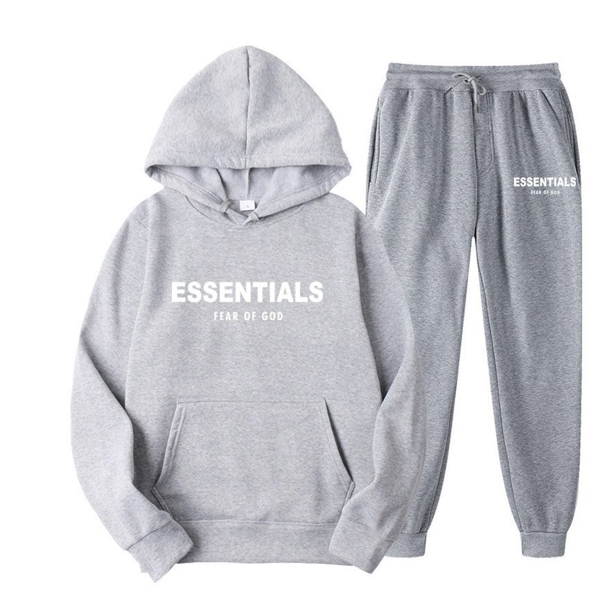 Essentials Hoodie Fear of God Light Gray TrackSuit A person wearing a light gray Essentials Hoodie and Fear of God tracksuit, showcasing the comfortable, relaxed fit.