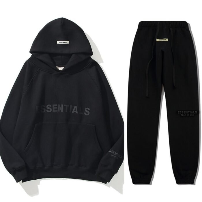 Fear Of God Essential Oversized Black Tracksuit A person wearing an oversized black Fear of God Essential tracksuit, showcasing the relaxed, baggy fit.